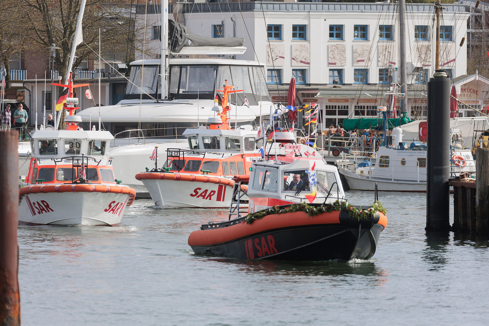 Ablegen zur ersten Fahrt unter dem endgültigen Namen: Die Seenotrettungsboote der Nachbarstationen begleiten die geschmückte JÜRGEN HORST.